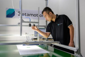 Zetamotion employee inspecting physical components of the Spectron platform offered by Zetamotion on the production line